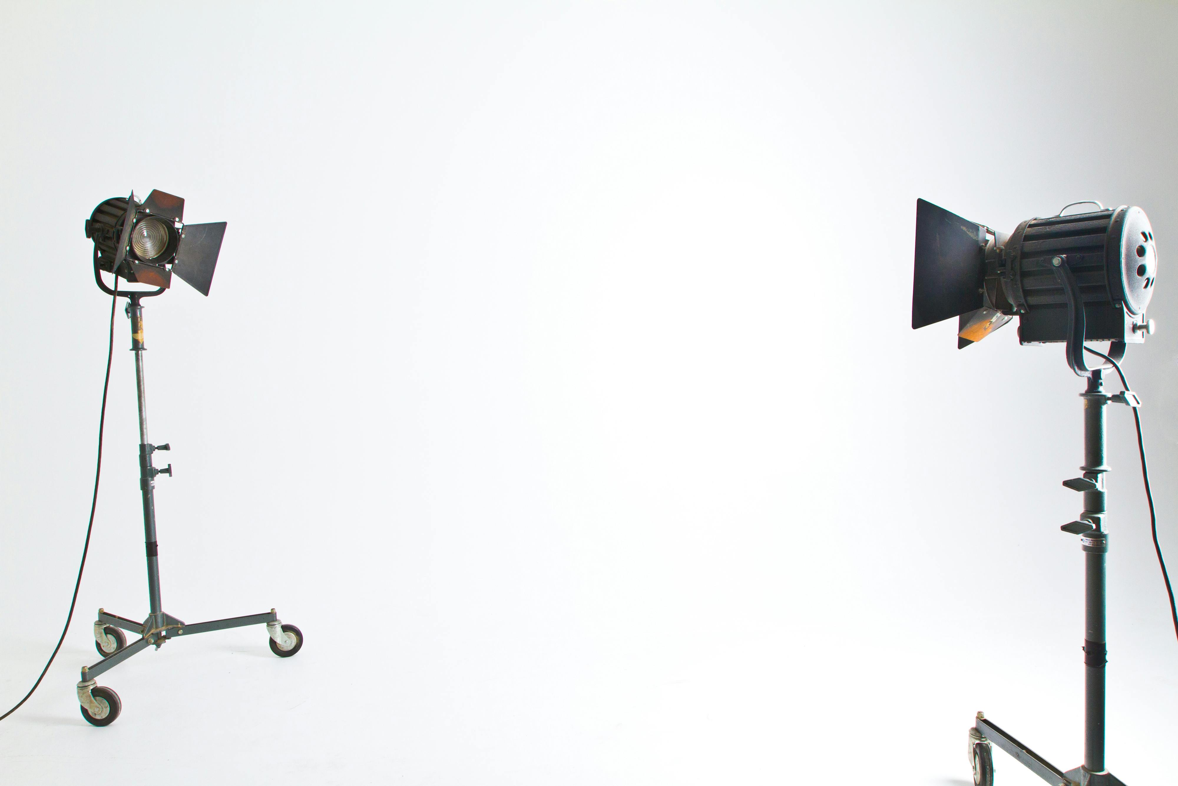 Studio floodlights set up in a professional photography environment with clean background.